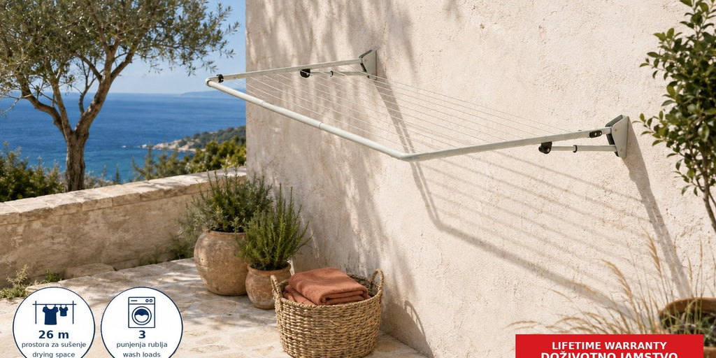 Hills Single Folding Frame Clothesline in Surfmist mounted in a coastal courtyard with towels drying on the lines.
