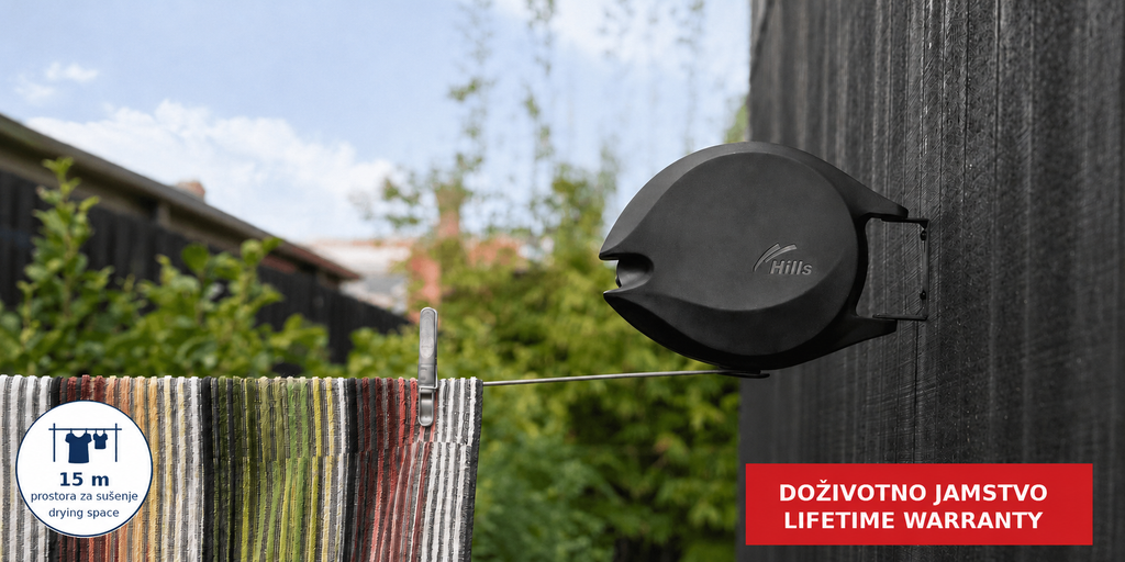 Hills Single Retractable Clothesline with 15 m drying line extended outdoors with a striped towel drying on the line.