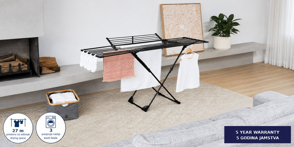 Hills Premium Extendable Drying Rack holding laundry in a modern living room.
