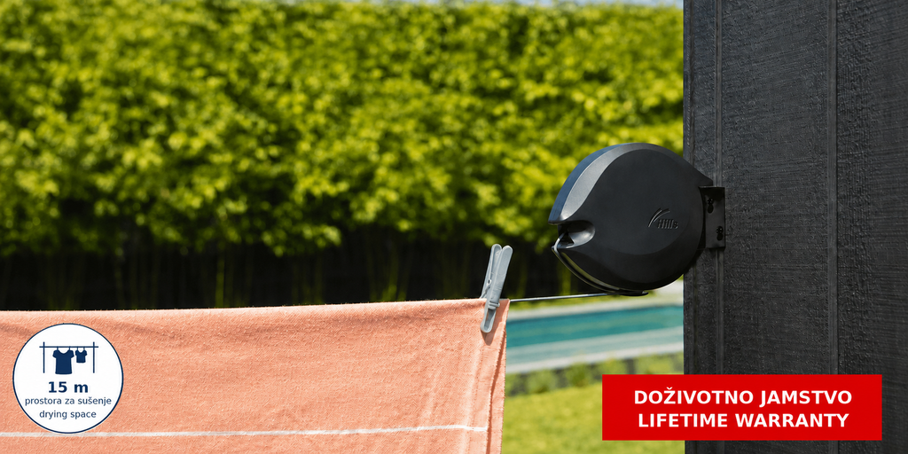 Hills Single Retractable Clothesline with 15 m drying line extended outdoors with a peach-coloured towel drying on the line.