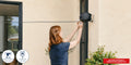Hills Double Retractable Clothesline with 30 m drying space in use with laundry drying on the lines.