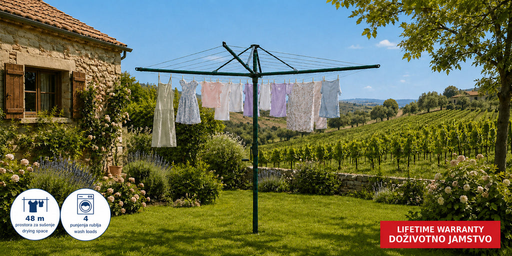 Hills Rotary 7 clothesline in Cottage Green fully open among flowering plants in a garden.