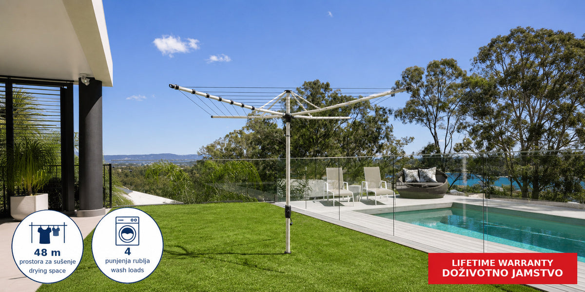 Hills Rotary 7 clothesline in Surfmist installed in a garden setting.